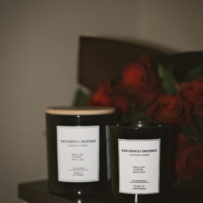 A warm, inviting setting featuring patchouli-scented candles and red roses on a table.